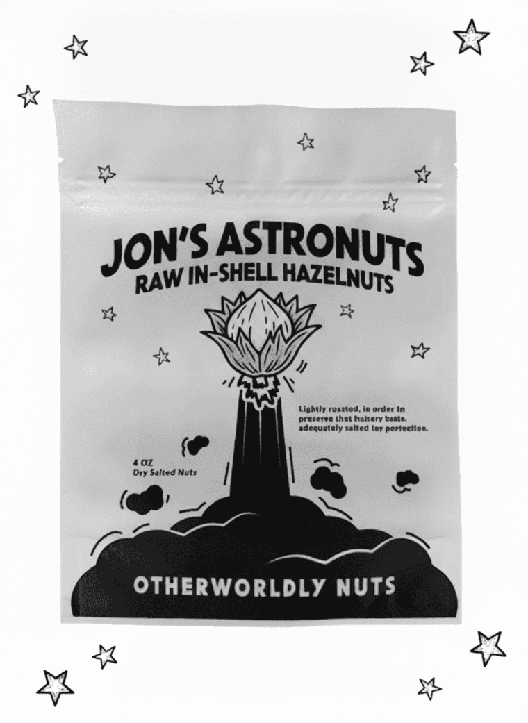 Jon's Astronuts raw in-shell hazelnuts pouch — black-and-white, husked nut on the rocket
